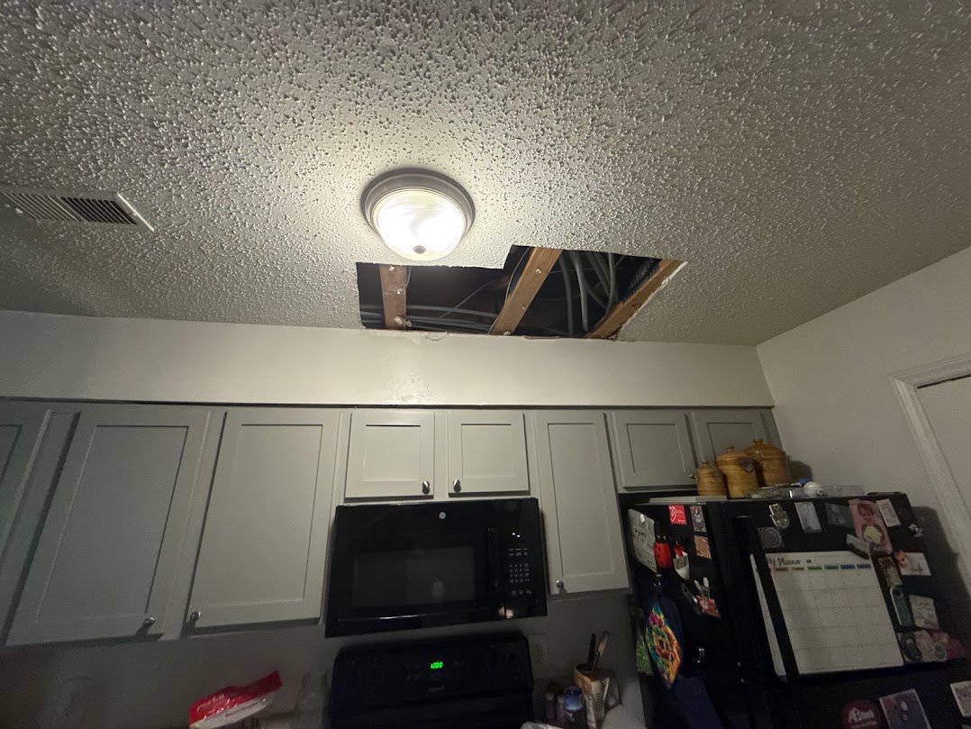 Damaged popcorn texture ceiling before repair