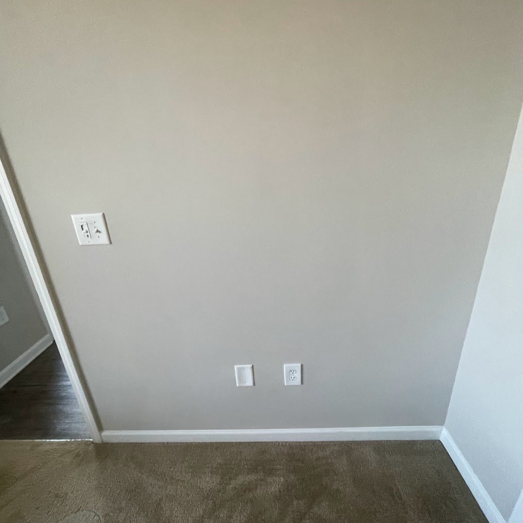Wall after electrical post-trade drywall patch, finish-ready